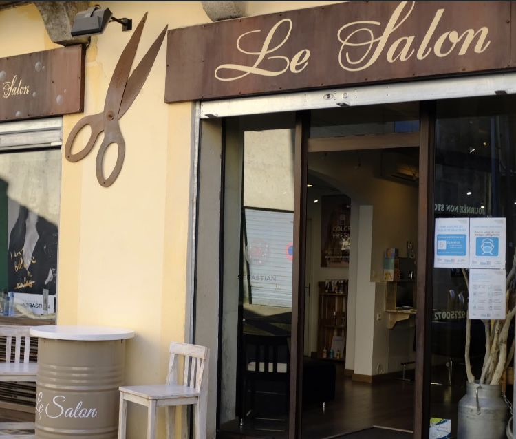La devanture du Salon acte II à Forcalquier : enseigne en cuivre « Le Salon » et grands ciseaux en métal
